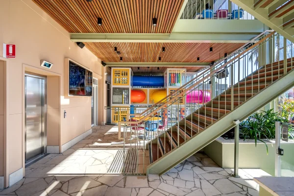 Outdoor area of Corrimal Hotel showing new staircase, new lift, outdoor dining area and children's playground.