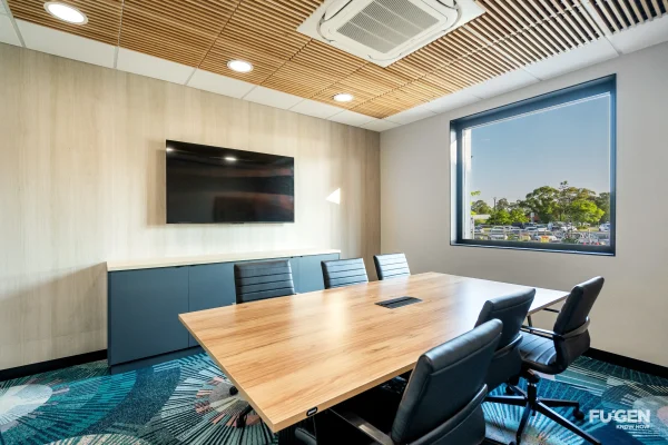 New office as part of the new administration area at Worrigee Sports club, featuring a large meeting desk with television on the wall and a large window providing good natural light